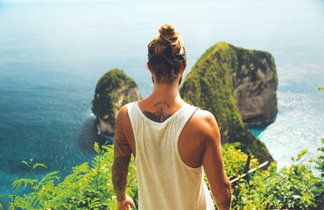 indonesia-man-looking-over-cliff-cover