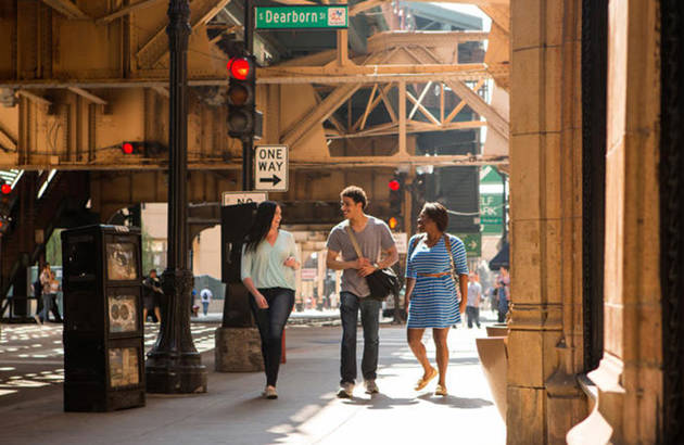 tre unge på studietur i chicago går på gaden ved dearborn