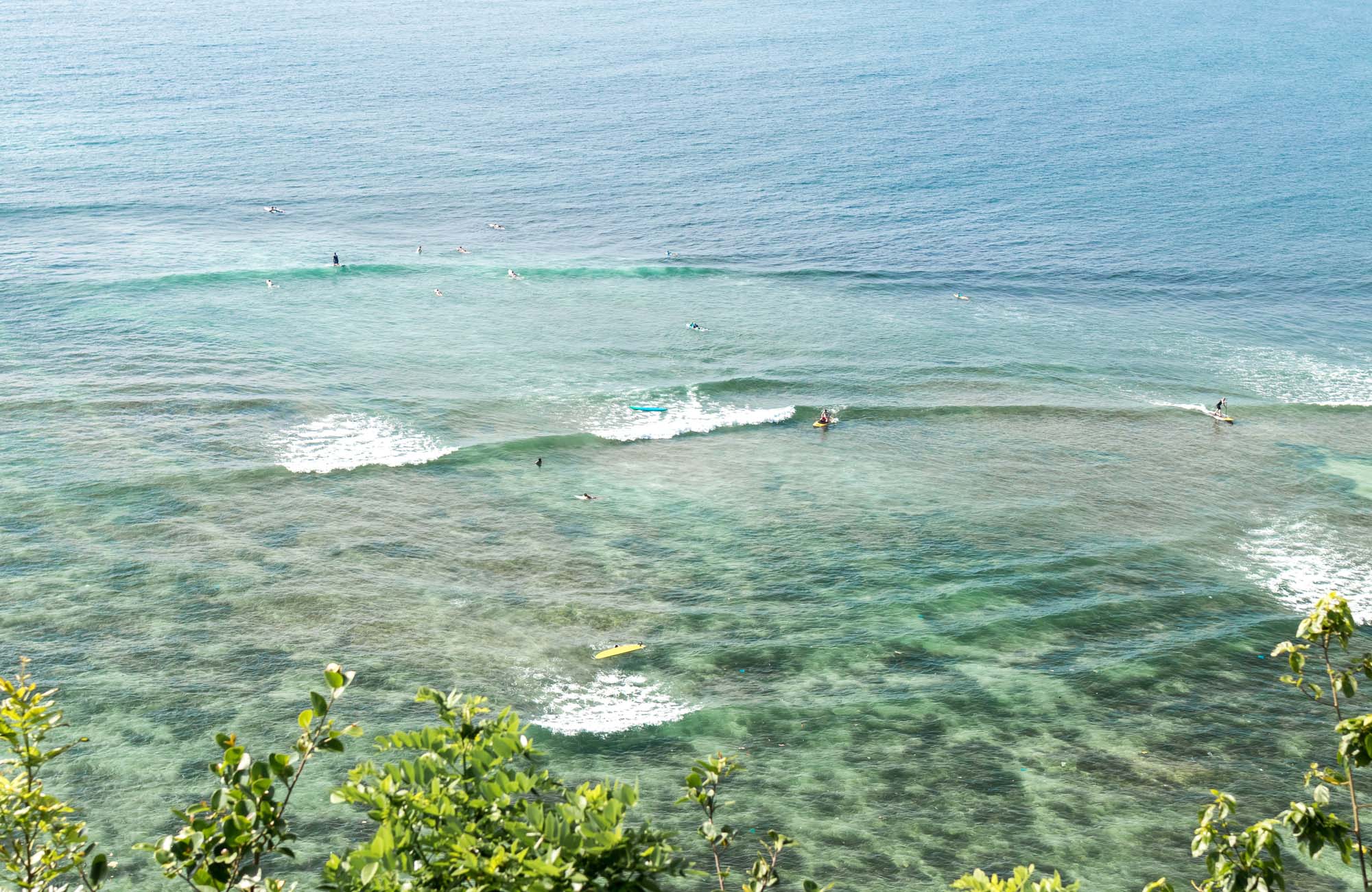 Group of surfers in the water in the ocean in Indonesia