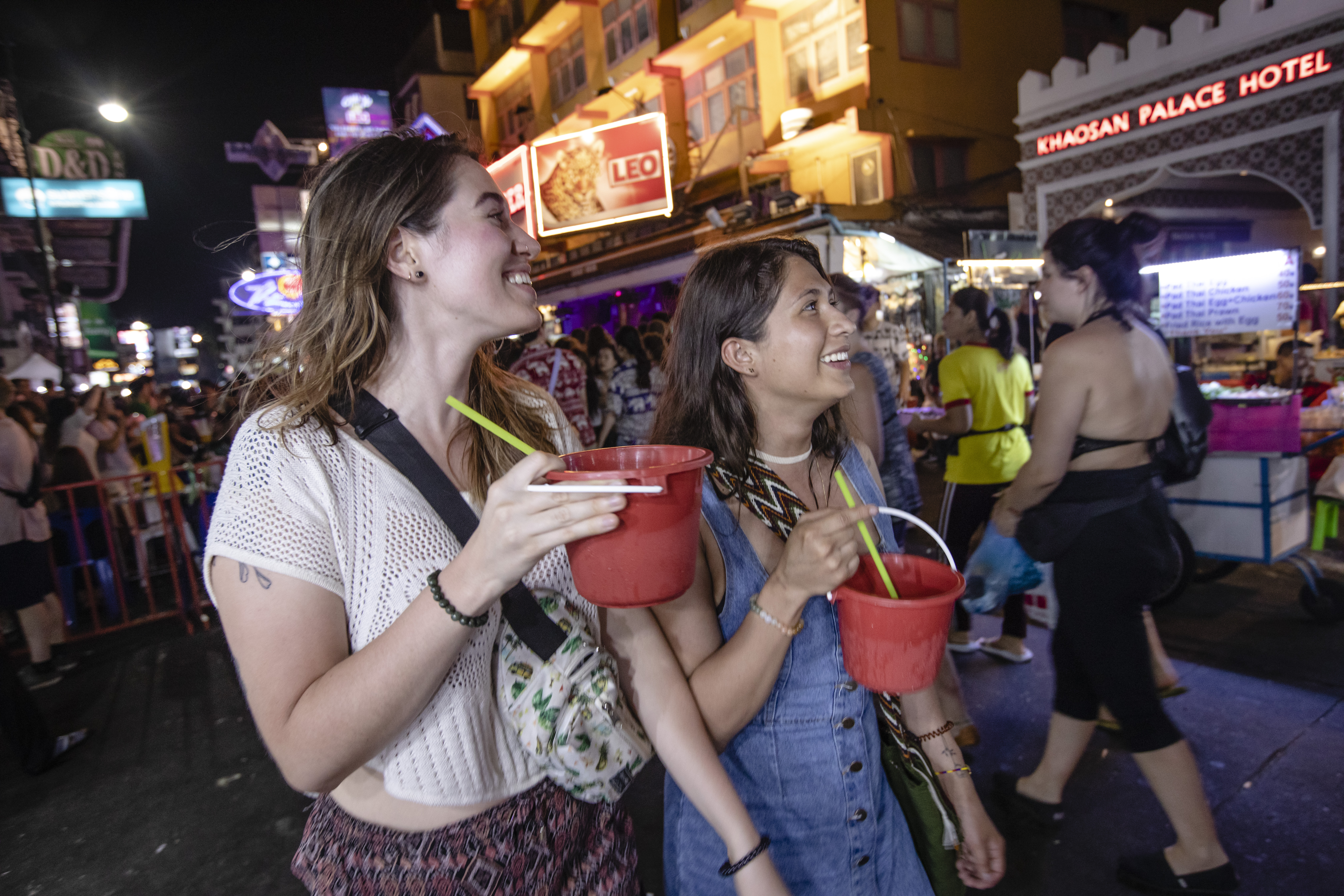 Thailand Bangkok Khao San Road Big Night Out Female Travellers Drinking Buckets Walking