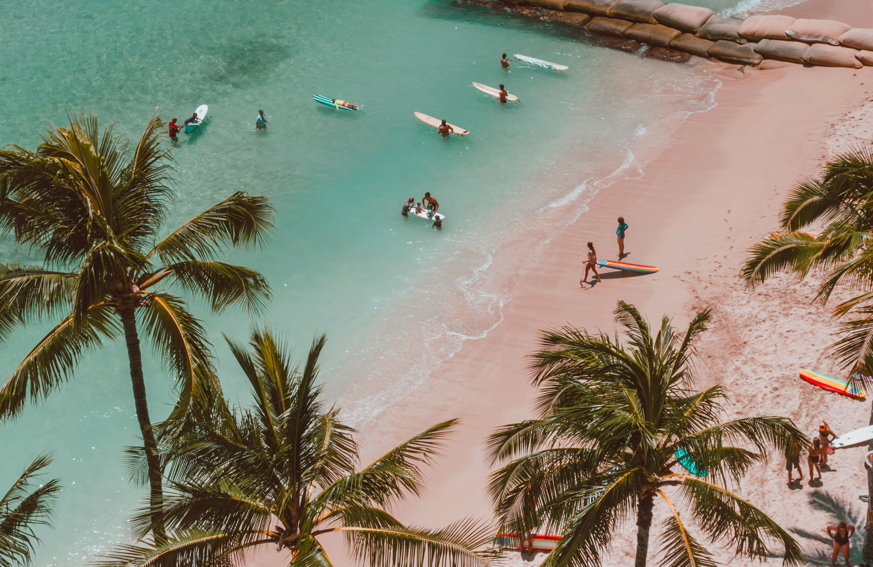 Surfers On A Tropical Beach On Hawaii