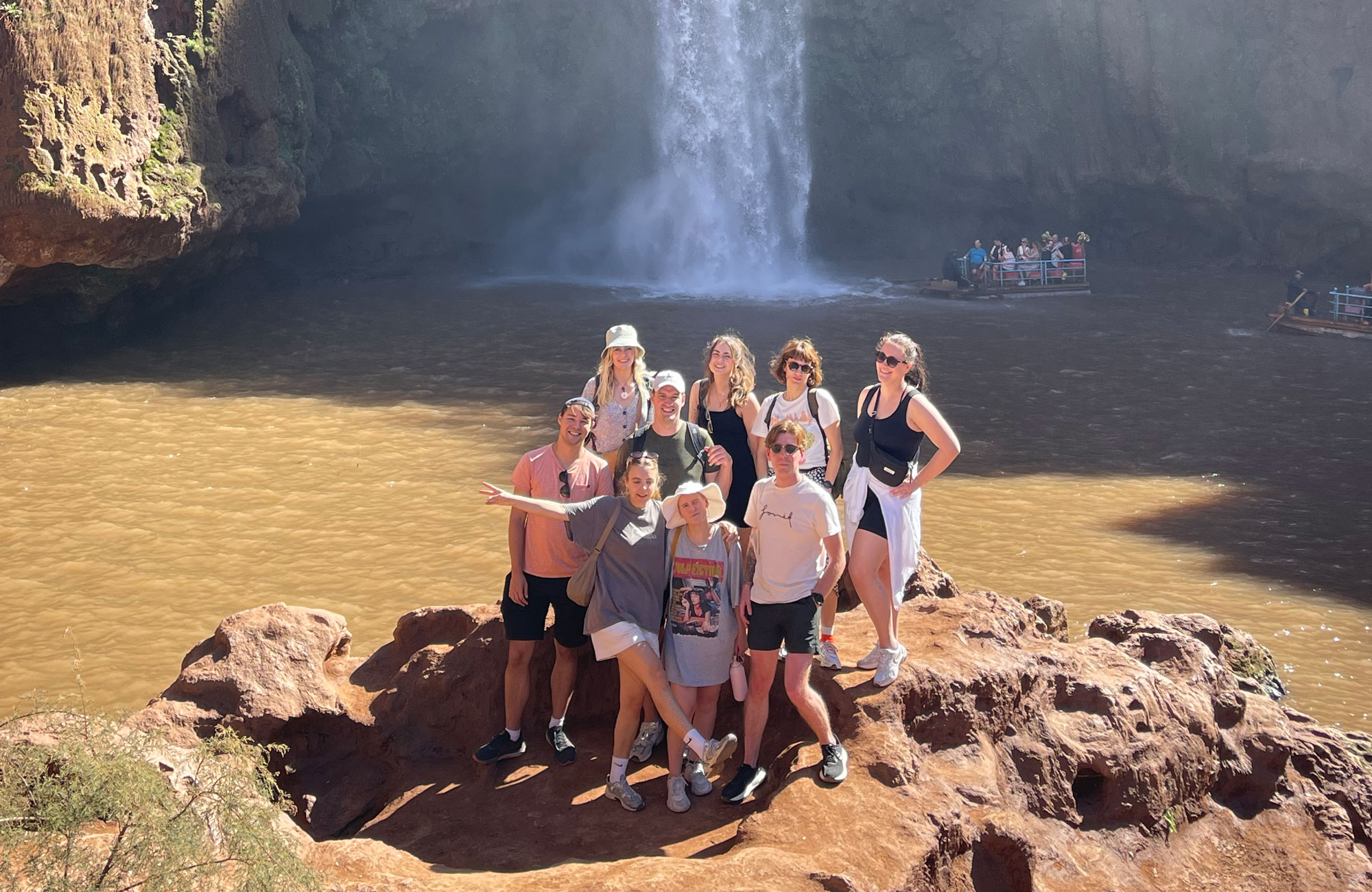 Group Of People In Front Of Waterfall